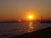 Slnko aj Nibiru zapadá nad Neziderskym jazerom v Rakusku